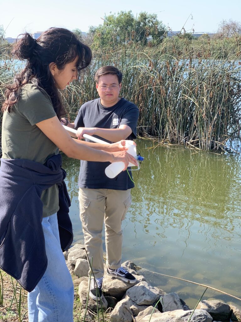 Students in an upper-division Ecosystem Ecology class sampling water from San Joaquin Marsh